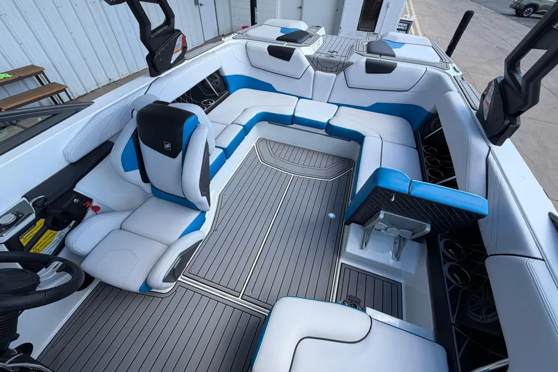 Slide: The Image of 2019 Nautique Super Air Nautique GS22 interior with blue and white seating, modern design. - 14