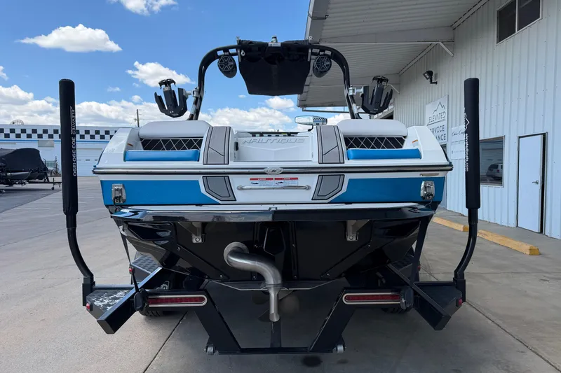 Slide: The Image of 2019 Nautique Super Air Nautique GS22 boat, rear view, parked at a marina. - 4