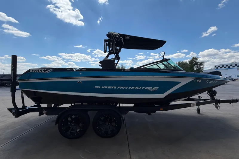 Slide: The Image of 2019 Nautique Super Air Nautique GS22 boat on trailer under blue sky. - 6