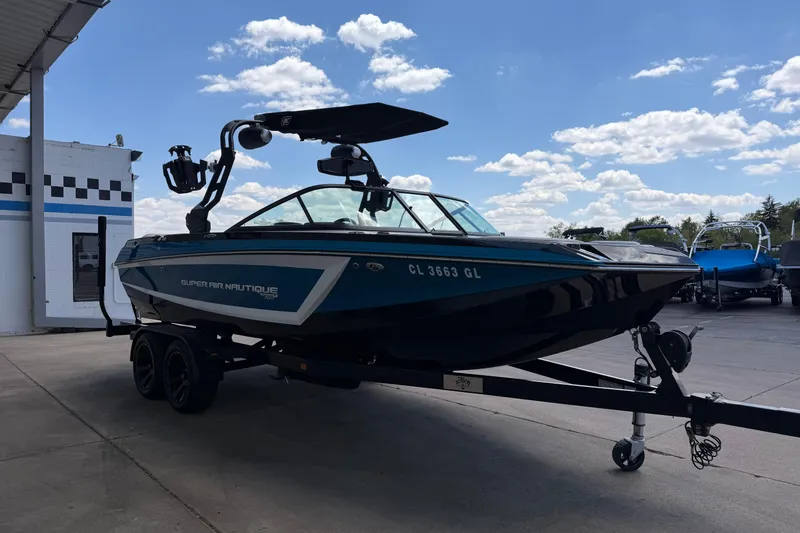 Slide: The Image of 2019 Nautique Super Air Nautique GS22 boat on trailer under blue sky. - 7
