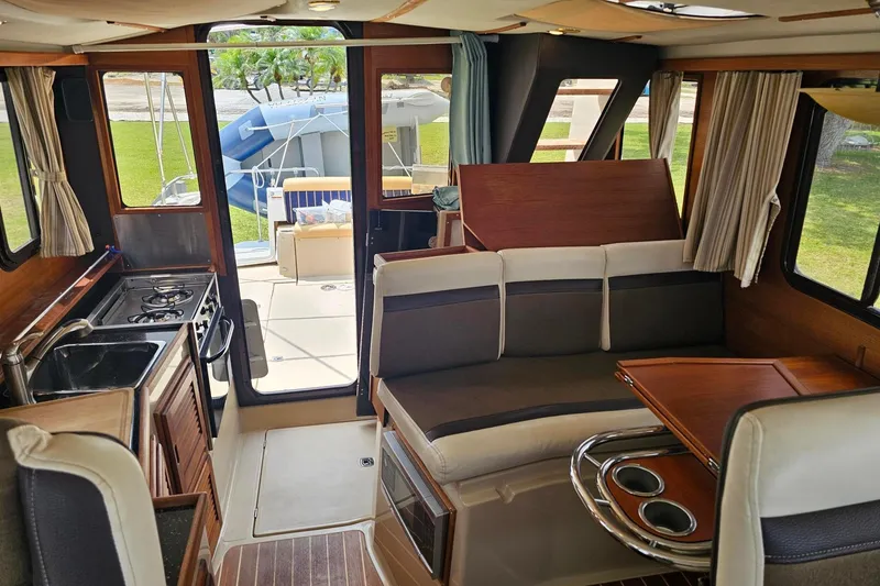 Slide: The Image of Interior of 2014 Ranger Tugs R-31 CB, featuring kitchen and seating area. - 10