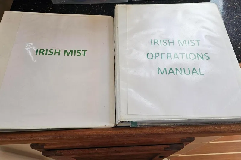 Slide: The Image of Irish Mist boat manuals on a table. - 18