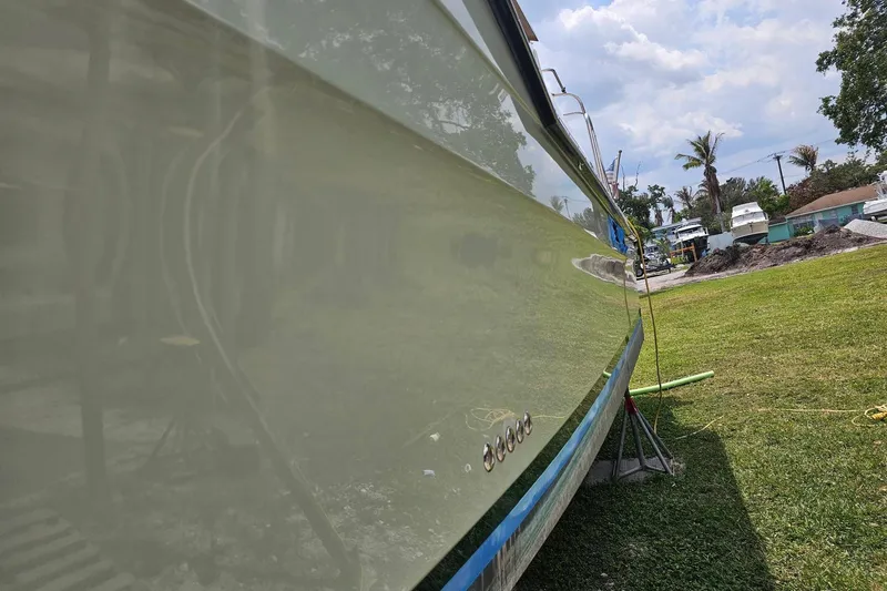 Slide: The Image of 2014 Ranger Tugs R-31 CB boat on grass, side view, sunny day. - 2