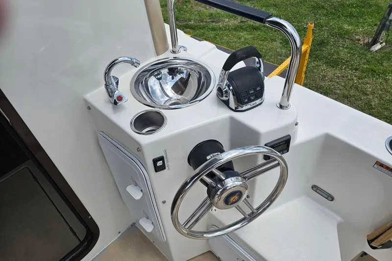 Slide: The Image of 2014 Ranger Tugs R-31 CB helm with steering wheel, throttle, and sink. - 3