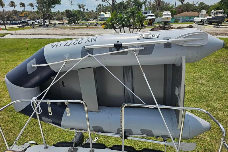 Slide: The Image of Inflatable dinghy mounted on a 2014 Ranger Tugs R-31 CB, parked on grass. - 5
