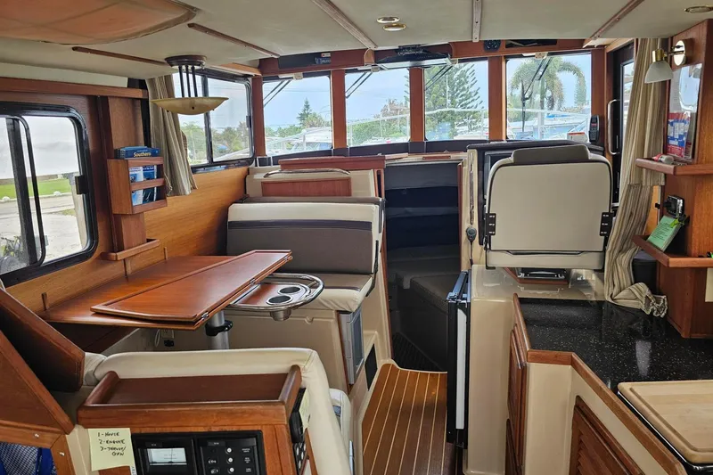 Slide: The Image of Interior of 2014 Ranger Tugs R-31 CB boat with wood accents and seating area. - 6