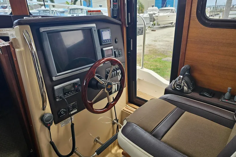 Slide: The Image of Interior helm of 2014 Ranger Tugs R-31 CB with steering wheel and navigation equipment. - 7