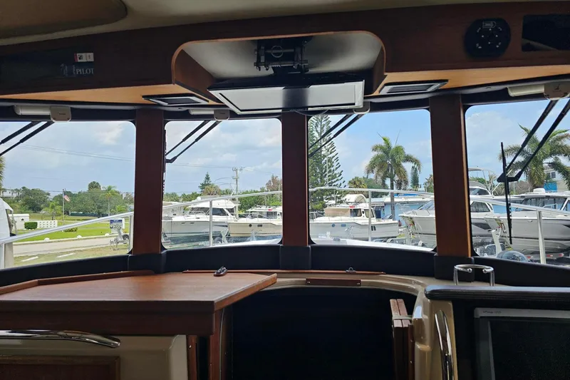 Slide: The Image of Interior view of 2014 Ranger Tugs R-31 CB, showcasing windows and marina scenery. - 8