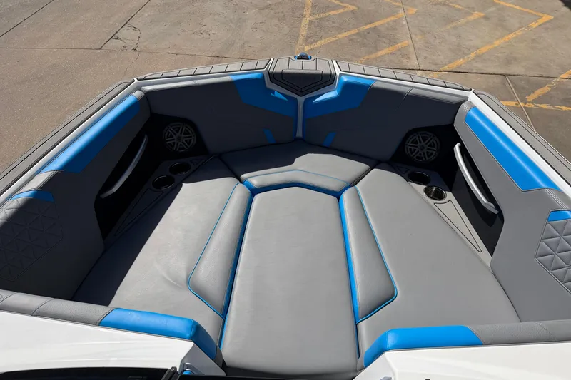 Slide: The Image of 2025 Nautique Super Air Nautique GS24 boat interior with blue and gray seating. - 13