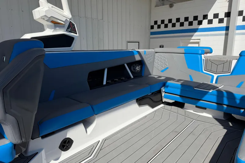 Slide: The Image of 2025 Nautique Super Air Nautique GS24 interior with blue and gray seating. - 16