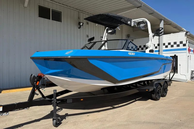 Slide: The Image of 2025 Nautique Super Air Nautique GS24 boat in vibrant blue on trailer. - 2
