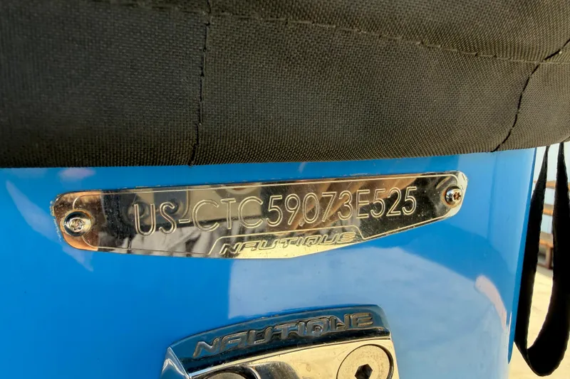 Slide: The Image of 2025 Nautique Super Air Nautique GS24 hull identification number on blue boat. - 24