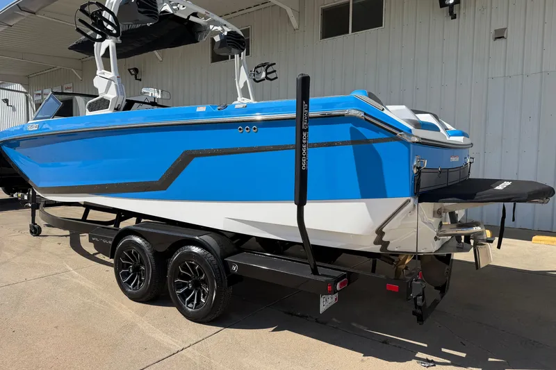 Slide: The Image of 2025 Nautique Super Air Nautique GS24 boat in vibrant blue on a trailer. - 3