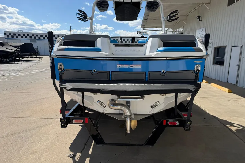 Slide: The Image of 2025 Nautique Super Air Nautique GS24 boat, rear view, parked outdoors. - 4