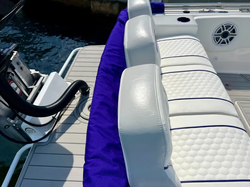 Slide: The Image of Luxurious boat seating on Concept 23 model 2025, white with blue accents. - 10