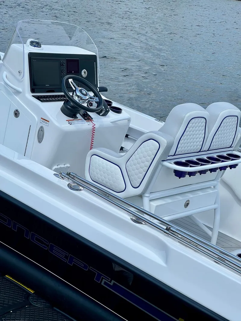 Slide: The Image of Luxurious cockpit of a Concept 23 boat, 2025 model, on calm water. - 14