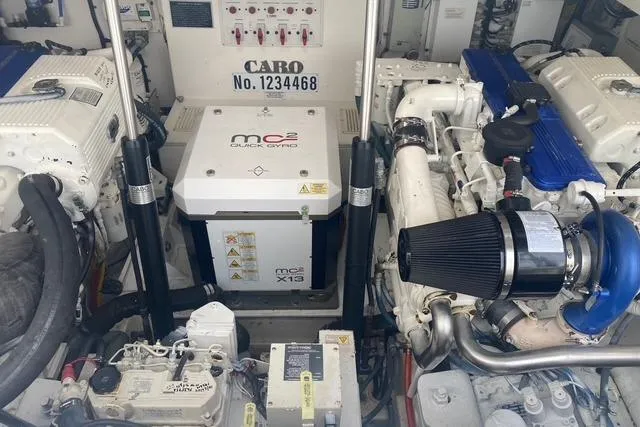 Slide: The Image of Engine room of a 2009 Cabo 35 Express boat, featuring mechanical components and systems. - 10