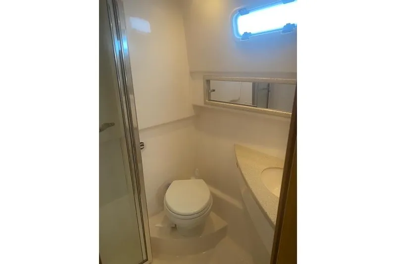 Slide: The Image of 2009 Cabo 35 Express yacht bathroom with toilet, sink, and shower. - 15