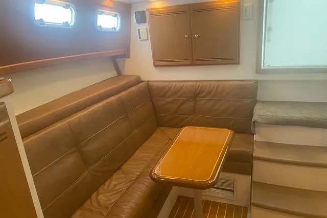 Slide: The Image of 2009 Cabo 35 Express interior with leather seating and wooden table. - 17