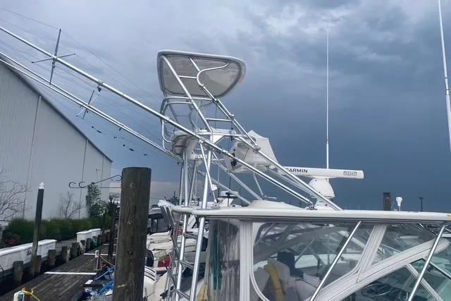 Slide: The Image of 2009 Cabo 35 Express boat docked under cloudy skies. - 18