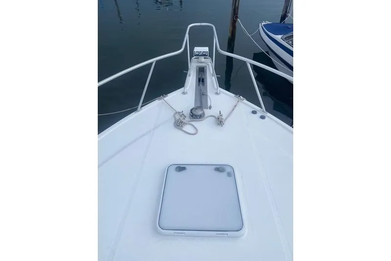 Slide: The Image of Bow of 2009 Cabo 35 Express boat with anchor and hatch. - 20