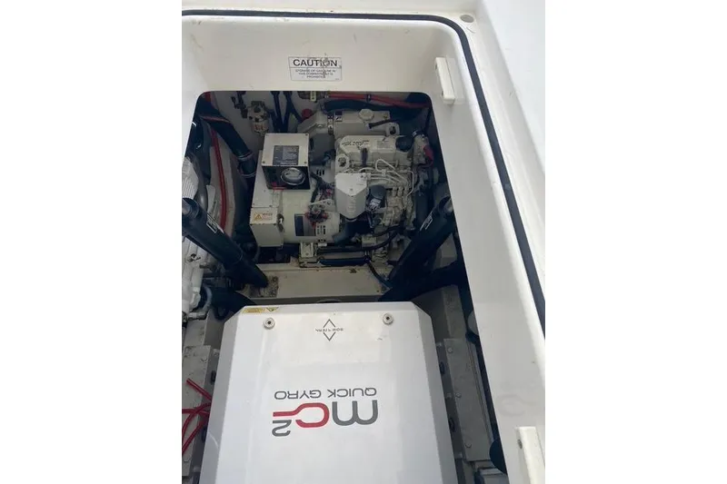 Slide: The Image of Engine compartment of a 2009 Cabo 35 Express boat, featuring mechanical components. - 23