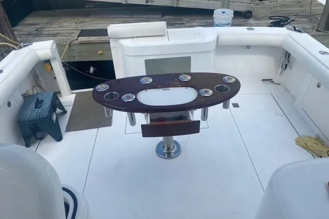 Slide: The Image of 2009 Cabo 35 Express boat deck with fishing rod holders and seating. - 24