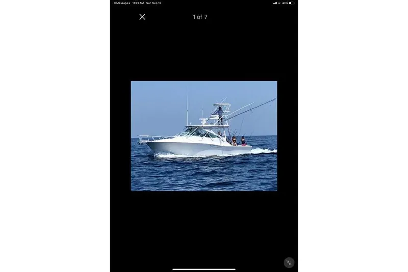 Slide: The Image of 2009 Cabo 35 Express boat cruising on open ocean waters. - 25