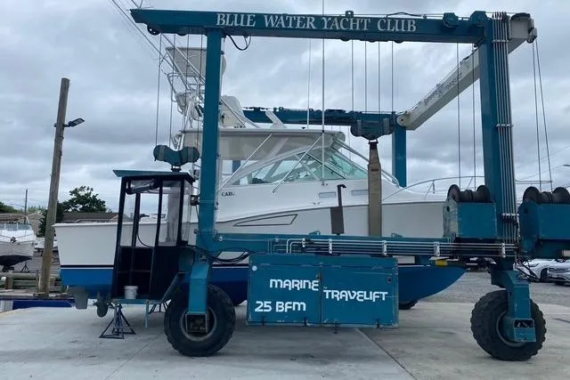 Slide: The Image of 2009 Cabo 35 Express yacht at Blue Water Yacht Club in a marine travel lift. - 3