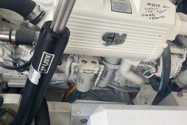 Slide: The Image of Engine compartment of a 2009 Cabo 35 Express boat, featuring mechanical components and hydraulic systems. - 5