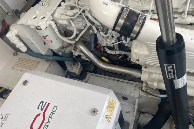 Slide: The Image of Engine compartment of a 2009 Cabo 35 Express boat, featuring mechanical components and a Seakeeper gyro stabilizer. - 6