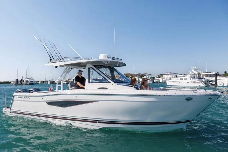 Slide: The Image of Manufacturer Provided Image: 2025 Solara S-310 CW boat cruising on clear blue water. - 2
