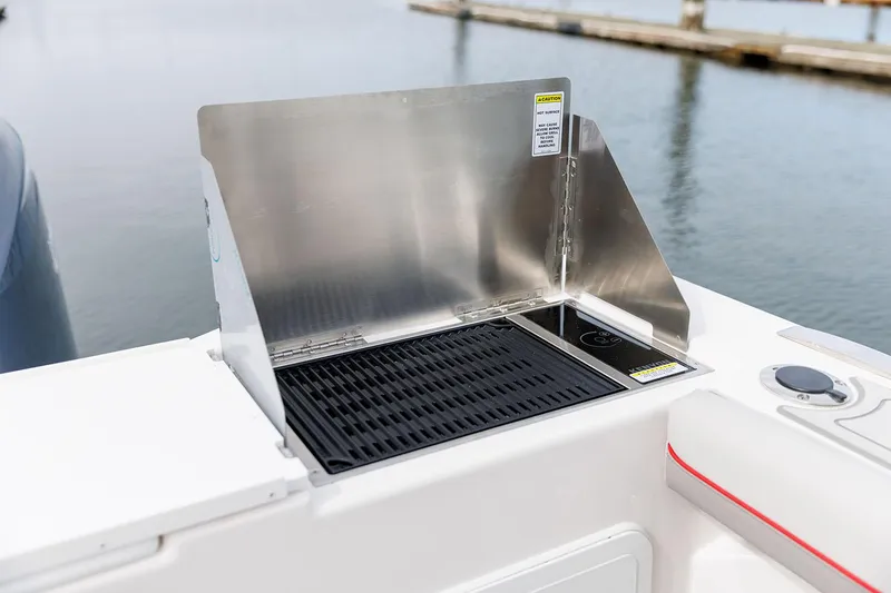 Slide: The Image of Manufacturer Provided Image: Outdoor grill on 2025 Solara S-310 CW boat by the water. - 21