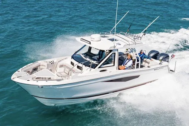 Slide: The Image of Manufacturer Provided Image: 2025 Solara S-310 CW boat cruising on open water, showcasing sleek design and powerful engines. - 3