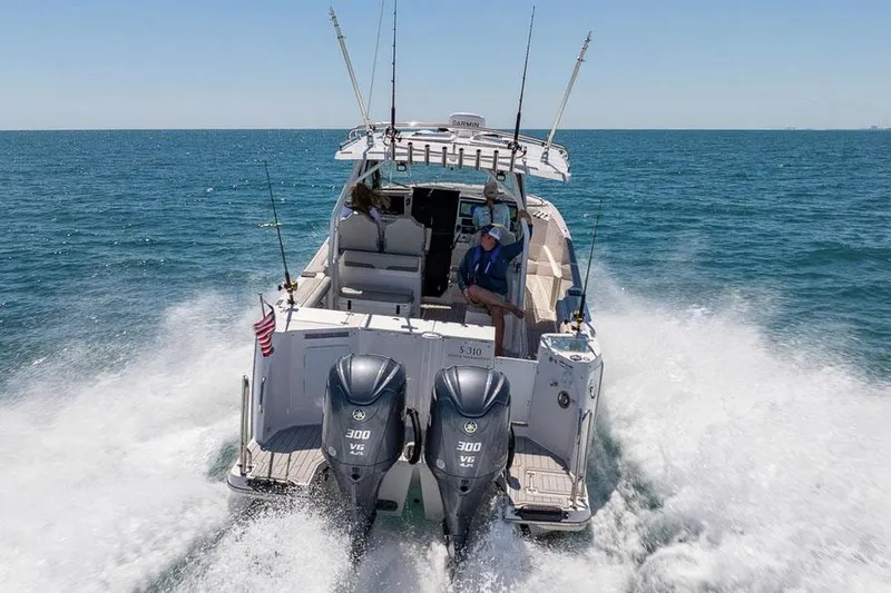 Slide: The Image of Manufacturer Provided Image: 2025 Solara S-310 CW boat cruising on open water with dual engines. - 5