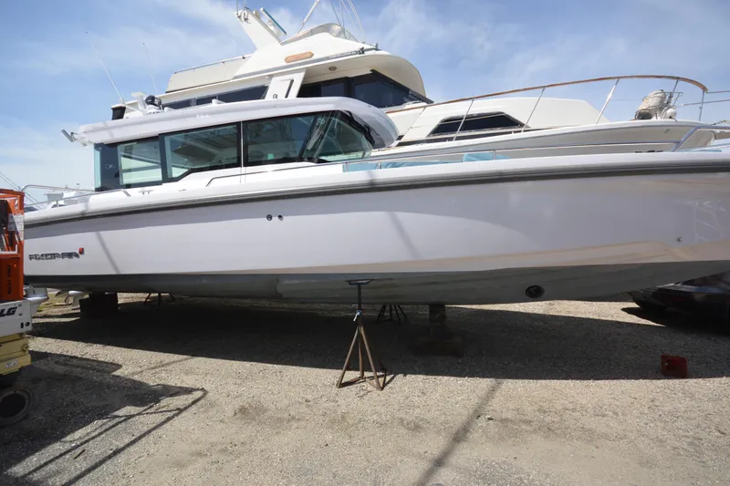 The Image of 2024 Axopar 37 XC Cross Cabin boat on dry dock, side view. - 0