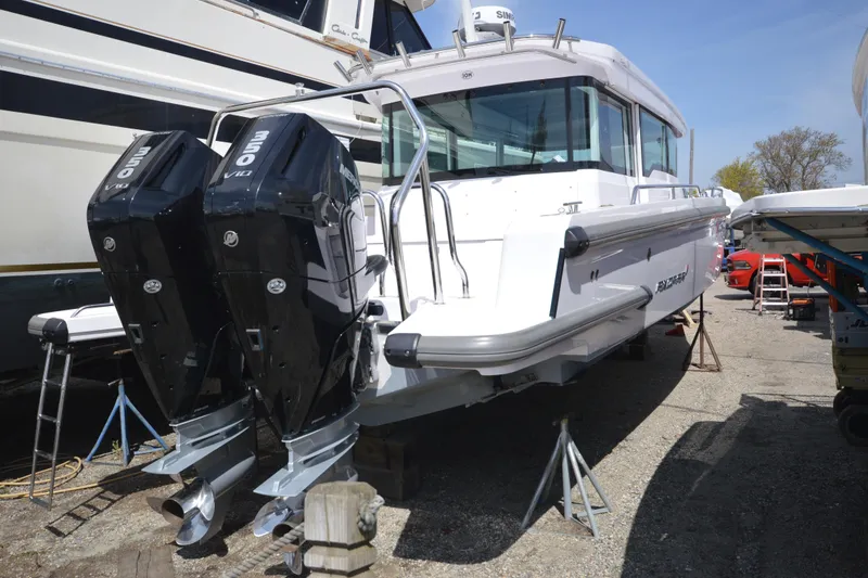Slide: The Image of 2024 Axopar 37 XC Cross Cabin with dual outboard engines on display. - 1
