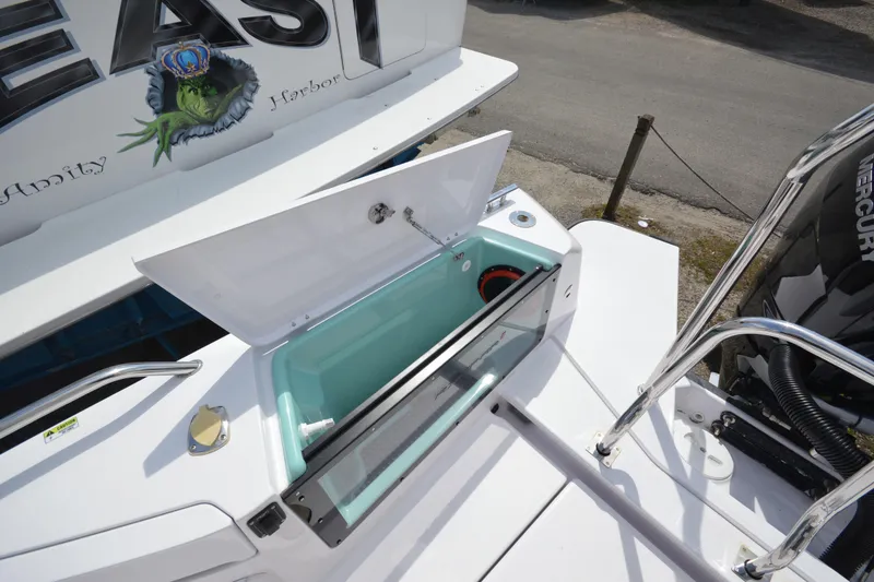 Slide: The Image of 2024 Axopar 37 XC Cross Cabin boat with open storage compartment and Mercury engine. - 12