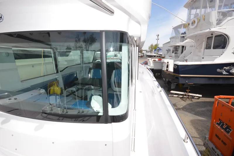Slide: The Image of 2024 Axopar 37 XC Cross Cabin boat docked, showcasing sleek design and spacious interior. - 16