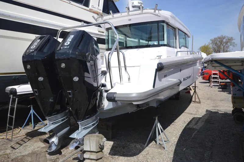 Slide: The Image of 2024 Axopar 37 XC Cross Cabin with dual outboard engines on display. - 2