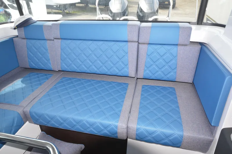 Slide: The Image of Luxurious blue seating in 2024 Axopar 37 XC Cross Cabin boat interior. - 21