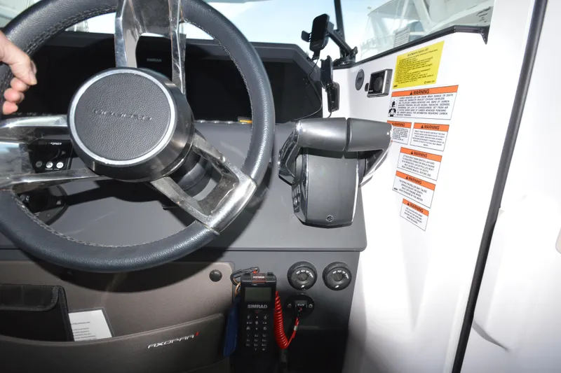 Slide: The Image of Steering wheel and controls of 2024 Axopar 37 XC Cross Cabin boat. - 25