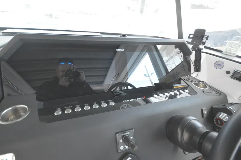 Slide: The Image of 2024 Axopar 37 XC Cross Cabin dashboard with modern controls and navigation system. - 29