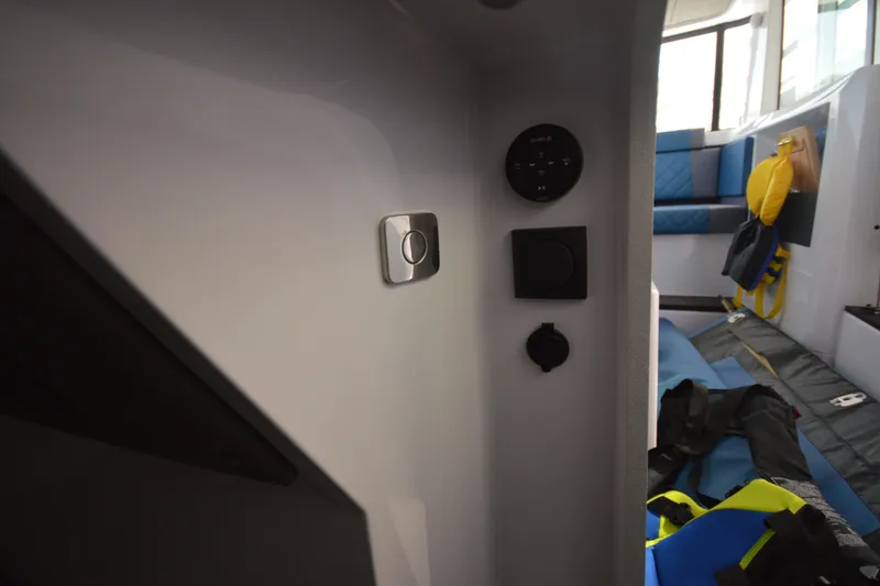 Slide: The Image of Interior view of 2024 Axopar 37 XC Cross Cabin with seating and control panel. - 32