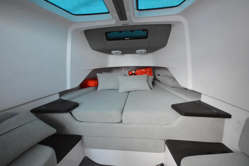 Slide: The Image of 2024 Axopar 37 XC Cross Cabin interior with modern gray seating and skylight. - 34