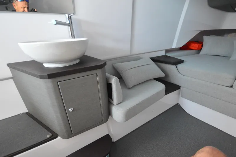 Slide: The Image of 2024 Axopar 37 XC Cross Cabin interior with modern sink and seating area. - 35