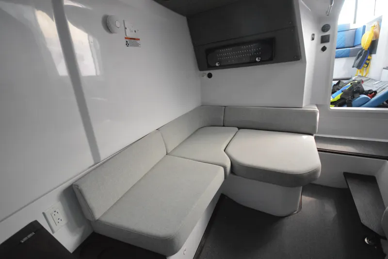 Slide: The Image of 2024 Axopar 37 XC Cross Cabin interior with gray seating and modern design. - 37
