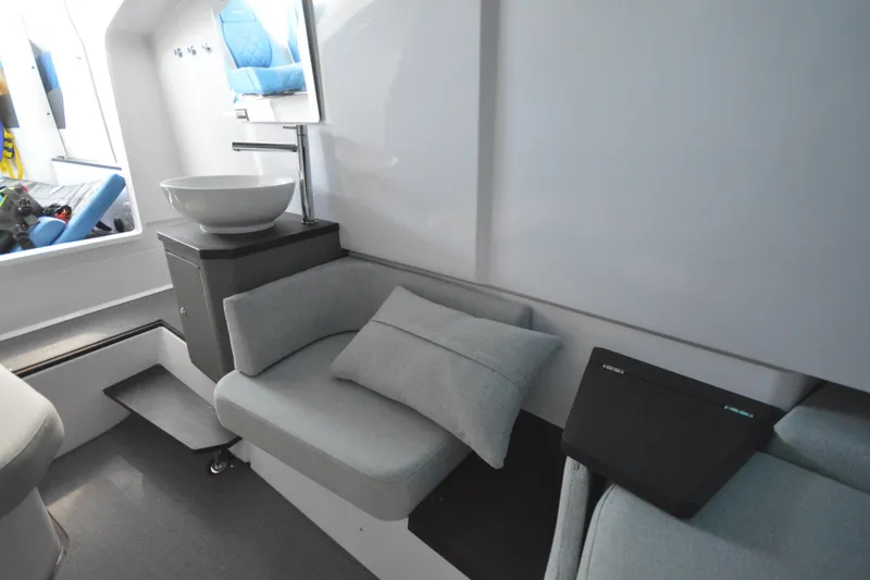 Slide: The Image of 2024 Axopar 37 XC Cross Cabin interior with modern seating and sleek basin. - 38