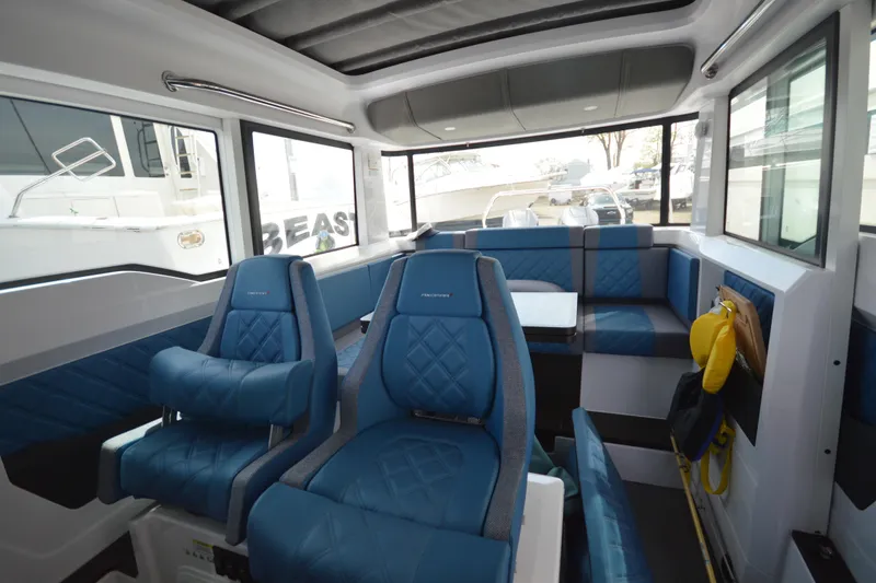 Slide: The Image of 2024 Axopar 37 XC Cross Cabin interior with blue seating and modern design. - 40