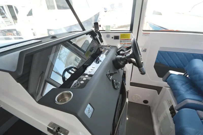 Slide: The Image of 2024 Axopar 37 XC Cross Cabin interior with modern dashboard and blue seating. - 41